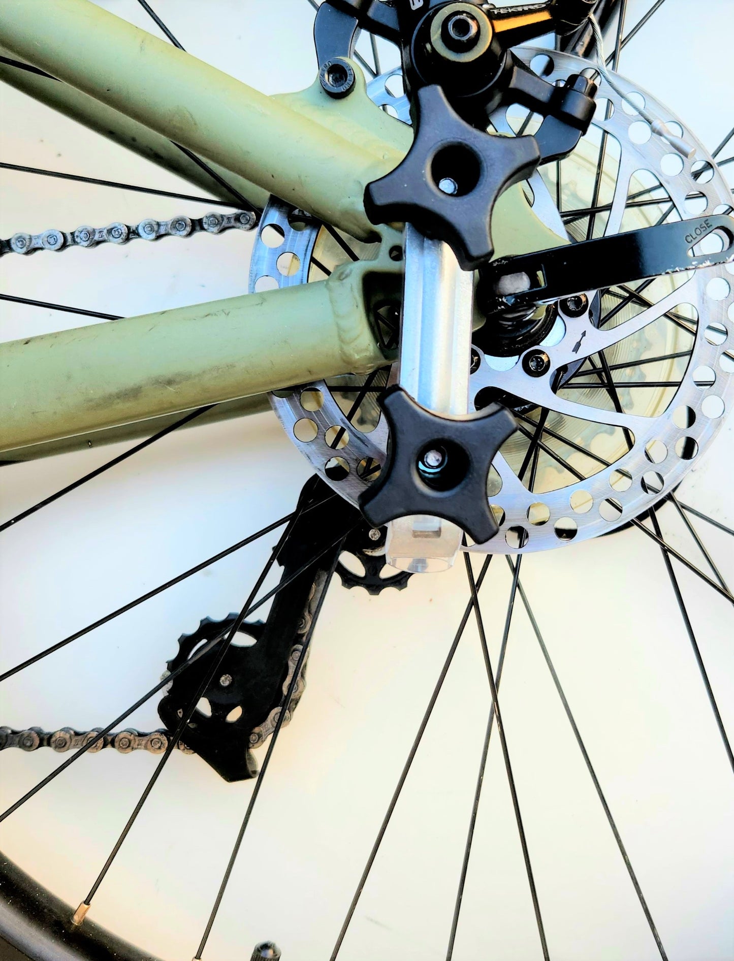 Extra Clamp, Knobs and Plate on a green bike as far back as possible