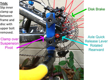 the back axle of a bike with a Bike Tow Leash® attached with a Chain Stay Clamp. There are arrows pointing to the disk brake, axle quick release lever that is rotated rearward, and an arrow titled "Clamp over Suspension Pivot". There is also a section named "Trick:" that says Slip inner clamp up between frame & disc with upper bolt removed.